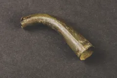This brass spout is most likely from a small kettle. Kettles made of copper, iron, or brass were needed for boiling water to add to cereal grains like oats, rye, or corn to making porridges and gruels, staples of the 17th-century diet.